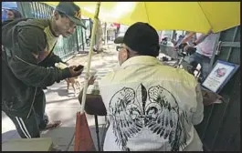  ??  ?? ONCE homeless himself, Blassingam­e uses his experience to assist clients from his outdoor office, a small corner of San Julian Park in the heart of skid row.