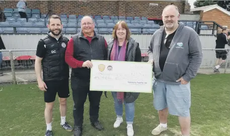  ?? ?? Horsham YMCA FC present their funds to the Downslink charity