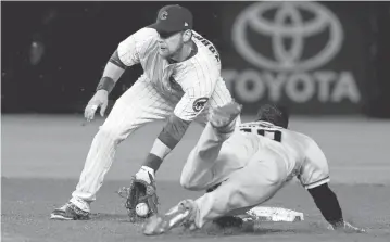  ?? CHARLES REX ARBOGAST/ASSOCIATED PRESS ?? The Cubs’ Ben Zobrist, left, takes the throw from catcher Willson Contreras and tags out the Giants’ Eduardo Nunez at second on a steal attempt in the fifth inning Tuesday.