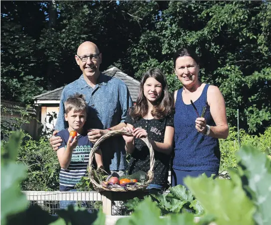  ?? PHOTOS: JEAN LEVAC ?? Conrad Melanson, left, Luca Gervais, Marianne Gervais and Anne-Marie Gervais have transforme­d their ordinary backyard into a bountiful vegetable garden