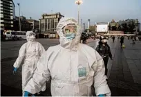  ?? KEVIN FRAYER/GETTY ?? People arrive March 13 at Beijing Railway Station in China.