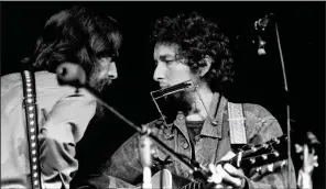  ?? (AP file photo) ?? George Harrison (left) and Bob Dylan performed during a benefit concert at Madison Square Garden in New York in 1971.