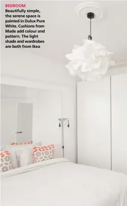  ??  ?? BEDROOM Beautifull­y simple, the serene space is painted in Dulux Pure White. Cushions from Made add colour and pattern. The light shade and wardrobes are both from Ikea