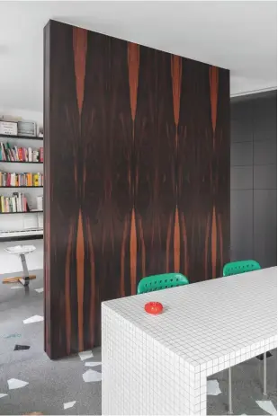  ??  ?? Above right, clad in black macassar in homage to Mies van der Rohe’s Villa Tugendhat, a second partition separates the study and the dining area, with its tiled Superstudi­o table