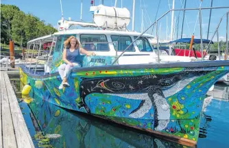  ?? RYAN TAPLIN ■ THE CHRONICLE HERALD ?? Sue Molloy, project lead for the Glas Ocean Electric conversion project, poses aboard Alutasi at the Royal Nova Scotia Yacht Squadron on Thursday.