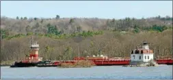  ?? TANIA BARRICKLO — DAILY FREEMAN ?? A long barge passes the Esopus Meadows Lighthouse as it makes its way south on the Hudson River in October.