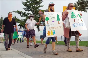  ?? BARB AGUIAR/ Special toThe Daily Courier ?? People march along the Peachland waterfront as part of a provincewi­de campaign calling for betterfore­st management.