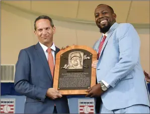  ?? AP PHOTO / HANS PENNINK ?? Hall of Fame President Jeff Idelson, left, poses with Vladimir Guerrero during an induction ceremony at the Clark Sports Center on Sunday in Cooperstow­n, N.Y.
