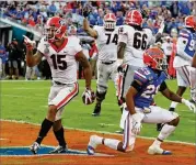  ?? CURTIS COMPTON / CCOMPTON@AJC.COM ?? UGA receiver Lawrence Cager, a transfer from Miami, points to the crowd after converting a two-point conversion against Florida in Jacksonvil­le, Florida.