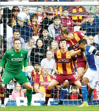  ??  ?? HEADS UP: Bradford City defender Matt Kilgallon clears the danger