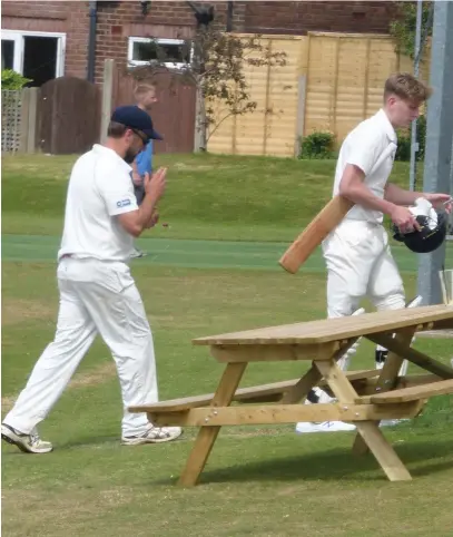  ??  ?? Marple’s Andy Wylie leads his team off at the tea interval after taking a terrific 6 for 43