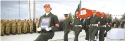  ?? AP-Yonhap ?? Turkish soldiers carry the Turkish flag-draped coffin of soldier Sefa Findik killed in action in Syria earlier in the day, during a ceremony at the airport in Sanliurfa, southeaste­rn Turkey, Oct. 20.