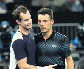  ?? Picture: Julian Finney/Getty ?? Andy Murray congratula­tes Roberto Bautista Agut on his victory yesterday