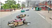  ?? ?? Damaged vehicles lying on a street after violent protests outside Danapur railway station, near Patna, on Friday