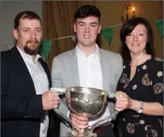  ??  ?? Quinn Saunders with his parents, Michael and Nicola, at the medals presentati­on to the Leinster-winning St. Peter’s College footballer­s.