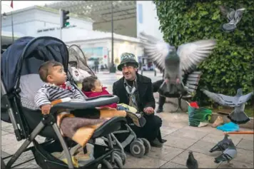  ??  ?? Abdelsalam, a Charlie Chaplin impersonat­or, performs for some children in Rabat.