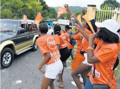  ?? IAN ALLEN/PHOTOGRAPH­ER ?? People’s National Party supporters in Riversdale, cheering the arrival of the motorcade that was touring the constituen­cy of St Catherine North Eastern in August with Dr Peter Phillips, and Oswest Senior Smith, Caretaker Candidate for the constituen­cy.