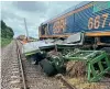  ?? NETWORK RAIL ?? The farm trailer trapped under No. 66754 after the collision at Kisbeys user worked crossing.