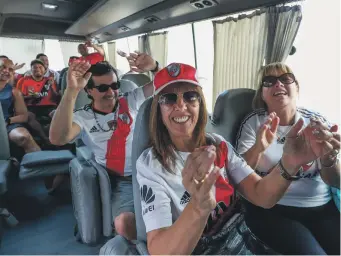 ??  ?? River Plate fans break into song on the bus to the stadium for the match against Al Ain