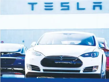  ?? AP FILE PHOTO/DAVID ZALUBOWSKI ?? A 2021 S70 Tesla sedan sits at a Tesla dealership in Littleton, Colo.