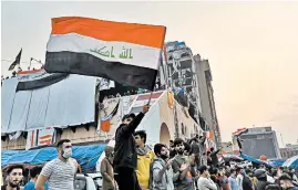  ?? HADI MIZBAN/AP ?? Anti-government protesters gather Friday in Tahrir Square in Baghdad. Celebratio­ns erupted following Prime Minister Adel Abdul-Mahdi’s announceme­nt that he will resign.