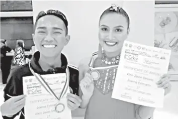  ??  ?? Joanna Esterado and Klein Jason Deluvio, both fourth year Bachelor of Secondary Education (BSED) students at the University of the Visayas (UV), proudly pose with their certificat­es and medals after emerging as grand champion in dancesport competitio­n of the Cebu Schools Athletic Foundation, Inc. (CESAFI) that was among the side events of the World DanceSport Federation (WDSF) Open 2018 and 10th DanceSport Sa Sugbu over the weekend at the Pacific grand ballroom of Waterfront Cebu City Hotel and Casino.