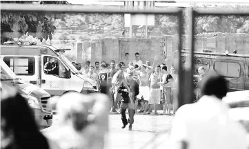  ??  ?? This photo shows families of prisoners watching guards move inmates at the ‘Coronel Odenir Guimaraes’ State Prison in Aparecida de Goiania, Goias, Brazil. — AFP photo