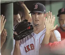  ??  ?? NICE JOB: Drew Pomeranz gets a hand from his teammates after coming out in the seventh inning.