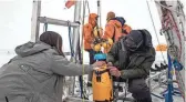  ?? DICHEK/ICEFIN/ITGC VIA AP ?? A robot nicknamed Icefin is deployed at Thwaites glacier in Antarctica in January 2020. The pencil-shaped robot is giving scientists their first look at the forces eating away at the Thwaites glacier.