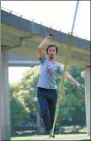  ?? PHOTOS BY ZHANG ZEFENG / CHINA DAILY AND ZHAO ZHONGJUN / FOR CHINA DAILY ?? Top: Zhang Liang rests on the slackline at Puzhehei, Yunnan province. Above: Zhang practices slacklinin­g in the space under high overpasses in Shanghai.