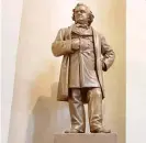  ??  ?? A statue of Stephen Douglas (left) inside the state Capitol and a sculpture of Pierre Menard and an unnamed Native American (right) on the Capitol grounds. House Speaker Michael Madigan is calling for statues of Douglas and Menard to be removed.