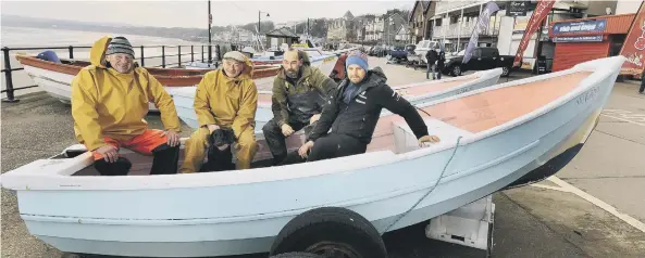  ??  ?? The fishermen of Filey rest their boats on the Cobble Landing. Fishermen Rex Harrison, Yogi Cammish and his dog Jack, Jamie Richardson and Matthew Wilkins.