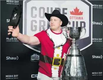  ?? ADRIAN WYLD/THE CANADIAN PRESS ?? Calgary Stampeders offensive lineman Quinn Smith poses with the trophy during Grey Cup Media Day in Ottawa, Thursday. The Stamps play the Toronto Argonauts in the 105th Grey Cup.