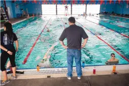  ?? MARLA BROSE/JOURNAL ?? A high school swim coach watches over his team at Los Altos pool in 2014. The city is using revenue bonds backed by gross receipts taxes to finance improvemen­ts to the building that houses the pool.