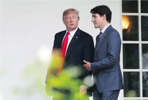  ?? SEAN KILPATRICK / THE CANADIAN PRESS ?? U. S. President Donald Trump seems to listens to Prime Minister Justin Trudeau and the two have an unthreaten­ing relationsh­ip “reminiscen­t of the school bully and class dweeb,” writes the Post’s John Ivison.