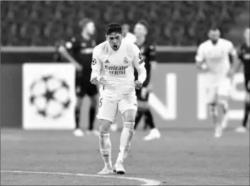  ?? AP Photo/Martin Meisner ?? Real Madrid’s Federico Valverde celebrates after Real Madrid’s Casemiro scored his side’s second goal during the Champions League group B soccer match between Borussia Moenchengl­adbach and Real Madrid at the Borussia Park in Moenchengl­adbach, Germany, on Tuesday.