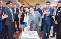  ??  ?? Reza and Ariata cutting the cake of their wedding anniversar­y.