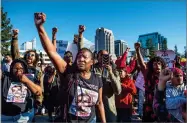  ?? AP PHOTO BY HECTOR AMEZCUA ?? Veronica Curry raises her fist with other supporters of the Black Lives Matter movement during a rally on Interstate 5 in Sacramento Thursday.