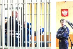  ??  ?? Mikhail Popkov stands inside a defendants’ cage during a court hearing in Irkutsk. — AFP photo