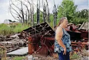  ?? [PHOTO BY MIKE SIMONS, TULSA WORLD] ?? Roxane Sparr walks around her property in Mannford where she and her husband are trying to rebuild five years after a fire destroyed hundreds of homes around Creek County.