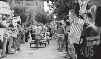  ?? [ADAM CAIRNS/DISPATCH] ?? Members of an advisory group reviewing possible sites for the 2016 Democratic National Convention arrive in 14 pedicabs at Nationwide Arena on Aug. 6, 2014. A public rally was organized to welcome the delegates to town in hopes of impressing them and...