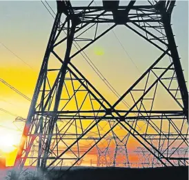  ?? /Mark Wessels/Sunday Times ?? Ageing: Eskom’s national grid of pylons carrying the country’s electricit­y hum at sunset near Melkbosstr­and, 35km from Cape Town.