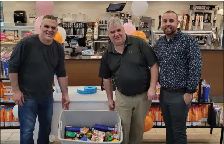  ?? ROGER SEIBERT — MEDIANEWS GROUP ?? COR Outreach Director Stuart Houck, left, joins Dunkin’ Donuts State Director Mark Hall and Regional Manager Seth Steele alongside some of the food donations given during the food drive.