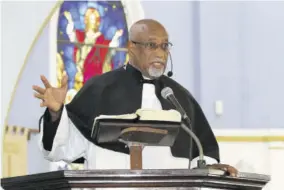  ??  ?? Rev Fr Franklyn Jackson, pastor at the Church of St Margaret’s delivering the sermon at the thanksgivi­ng service for Winsome Samms-paterson.