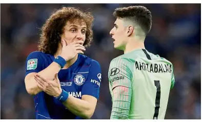  ??  ?? Listen to the gaffer: Chelsea’s David Luiz (left) talking to Kepa Arrizabala­ga during the English League Cup final against Manchester City at Wembley on Sunday. — Reuters