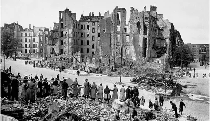  ??  ?? ‘Rubble women’ pass the debris from a bombed Berlin building along a line to a nearby dump, July 1945. Did the destructio­n of Germany’s cities make its people more amenable to the idea of democracy?