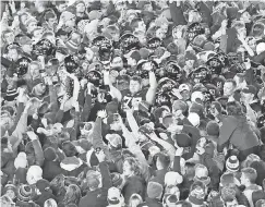  ?? REESE STRICKLAND/ USA TODAY SPORTS ?? Students and fans rushed the field Saturday night after Iowa State toppled previously unbeaten and No. 6 West Virginia 30-14.