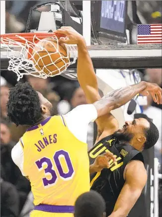  ?? Rick Bowmer Associated Press ?? FORMER LAKER Talen Horton-Tucker dunks on Damian Jones as the depleted Lakers never really got close in the second half and fell to the Jazz for the second time in four days.