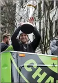 ?? TED S. WARREN — ASSOCIATED PRESS ?? Seattle Sounders midfielder and captain Nicolas Lodeiro holds up the MLS Cup trophy Tuesday during a parade to celebrate MLS Cup champions in Seattle.