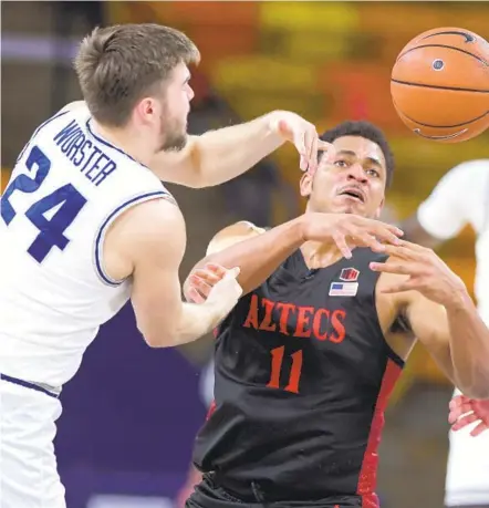  ?? ELI LUCERO THE HERALD JOURNAL VIA AP ?? Utah State guard Rollie Worster (24) and San Diego State forward Matt Mitchell (11) go after a loose ball. Mitchell was later injured.